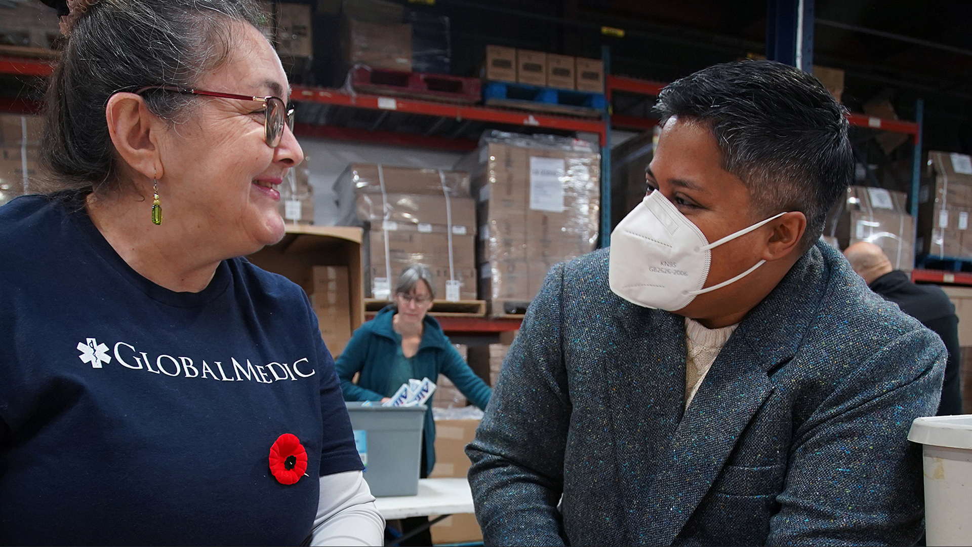 Lauren Pragg, Interim Executive Director, Lesbian Gay Bi Trans Youth Line, (right) shares a post-press-conference smile with a volunteer.