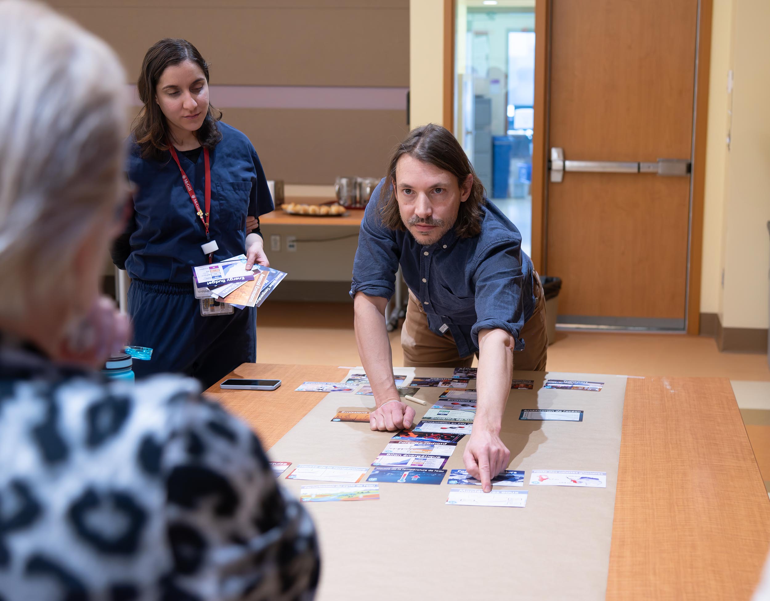 Michael Brard, moderating a game of “Le Fresque du climat” at La Maison du développement durable, in Montreal (Supplied photo)