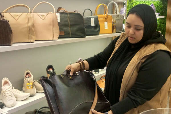 Karima Bakr, the shop’s sales manager, shows off a purse for sale at Mersal Shop. (Faten Sohbi/Egab)