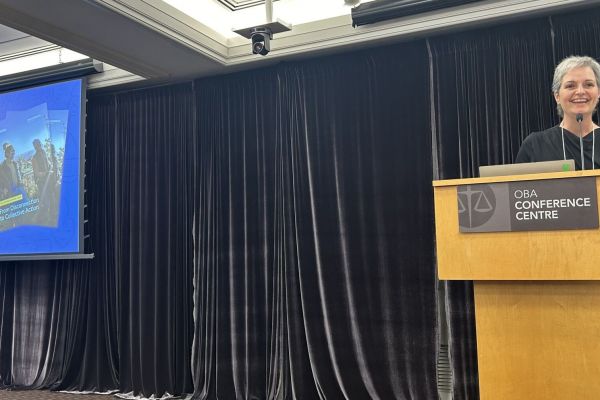 Image Caption: Julie Fiorini, general manager of charity and donor services at CanadaHelps, speaks at a conference in 2024 (CanadaHelps / Facebook)