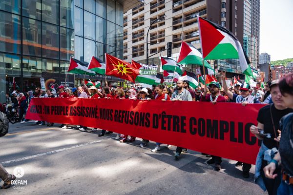 A protest takes place in downtown Montreal, denouncing Canada’s role in the ongoing genocide in Palestine (Oxfam Quebec / Facebook)