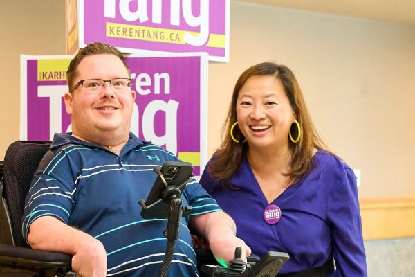 Image Caption: Disability advocate Zachary Weeks with Edmonton City Councillor Keren Tang, who brought forward a motion to pause the rollout of the province’s new disability assistance program (Zachary Weeks / Facebook)