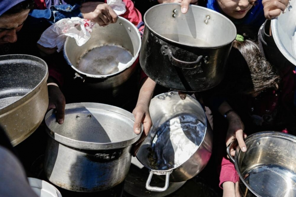 Starving children hold empty pots in Gaza.
