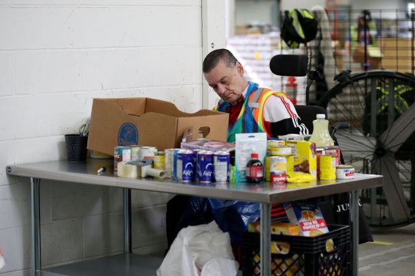 Volunteers sort donations at Harvest Manitoba, which distrubutes food to more than 380 community organizations including foodbanks, in Winnipeg on May 29, 2025. Photo: Shannon VanRaes