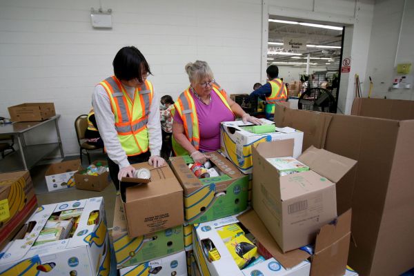 Volunteers sort donations at Harvest Manitoba, which distrubutes food to more than 380 community organizations including foodbanks, in Winnipeg on May 29, 2025. Photo: Shannon VanRaes
