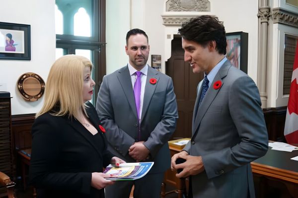 Canadian Centre for Child Protection Executive Director Lianna McDonald speaks to MP Ben Carr and Prime Minister Justin Trudeau in November, 2023. (Ben Carr/Facebook)